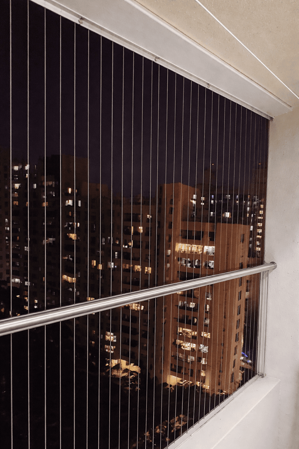 Invisible balcony grills installation in Mumbai with safety stainless steel cables and clear city view